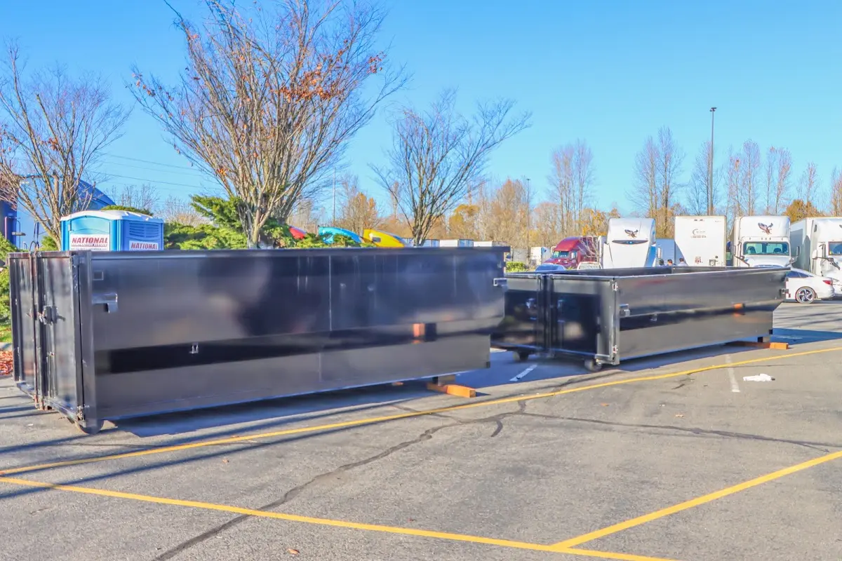 Professional dumpster rental service with roll-off container on residential driveway in Naugatuck